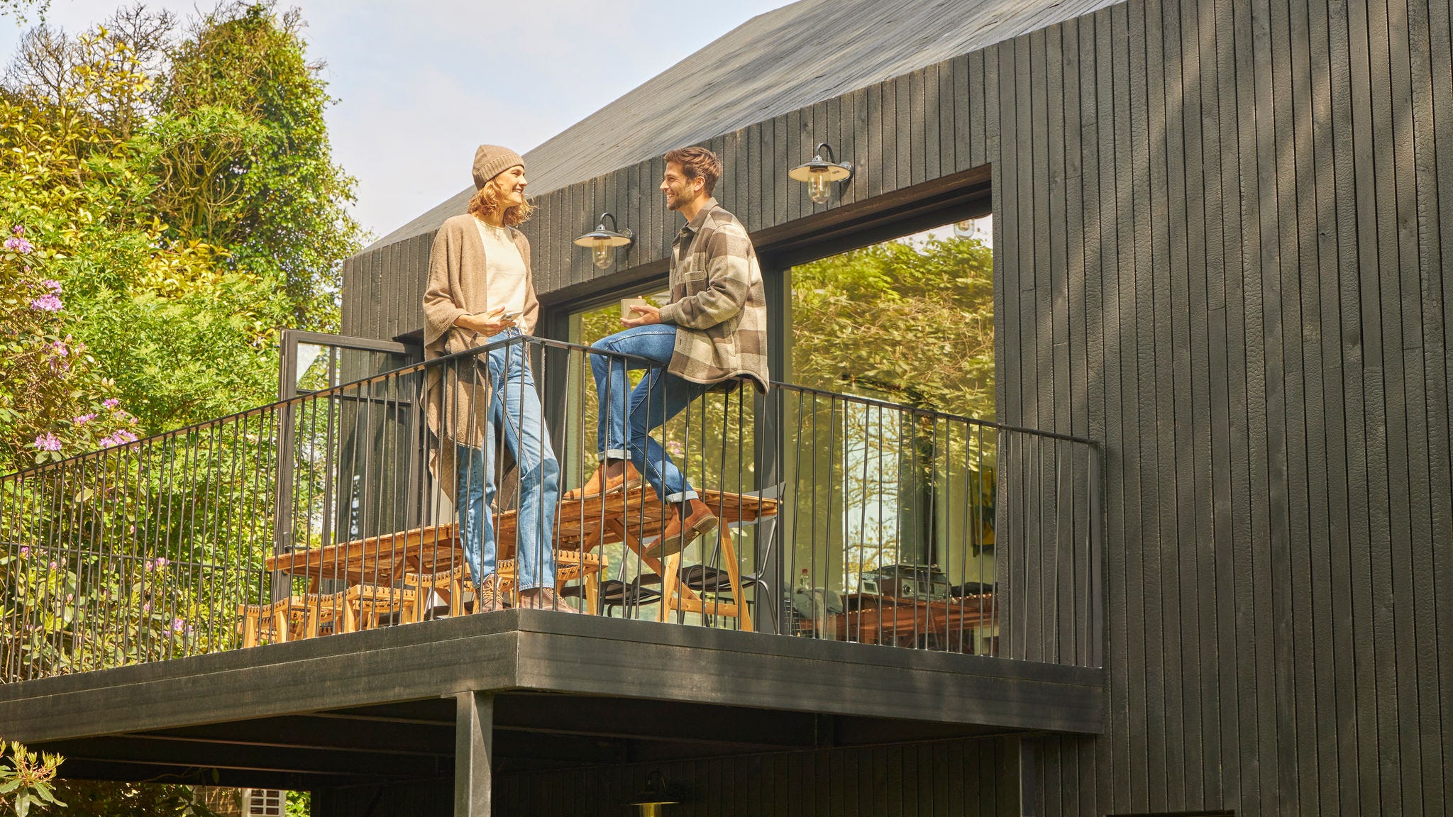 Ein Ehepaar diskutiert auf der Terrasse eines Bungalows in der Natur